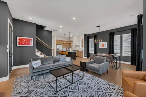 a living room with furniture and a rug