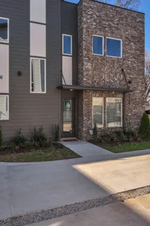 front view of a brick house with a yard