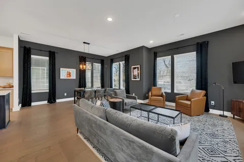 a living room with furniture and large windows