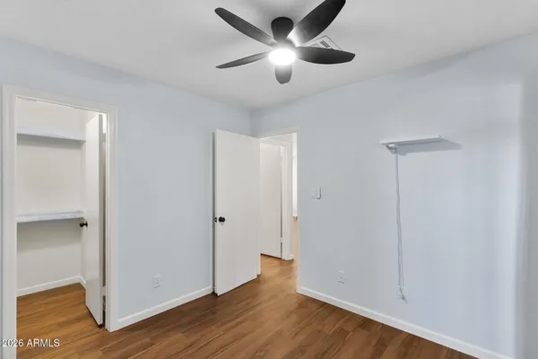 a view of an empty room with wooden floor