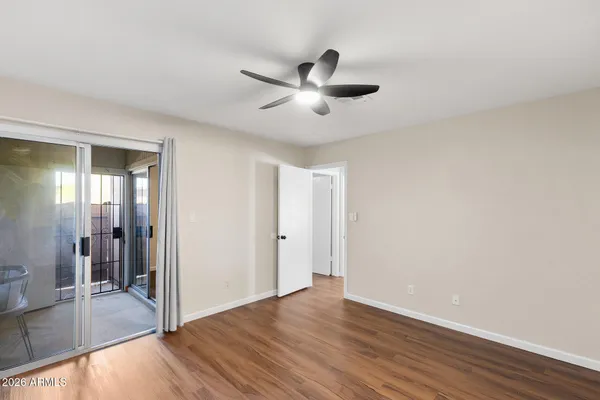 a view of empty room with wooden floor
