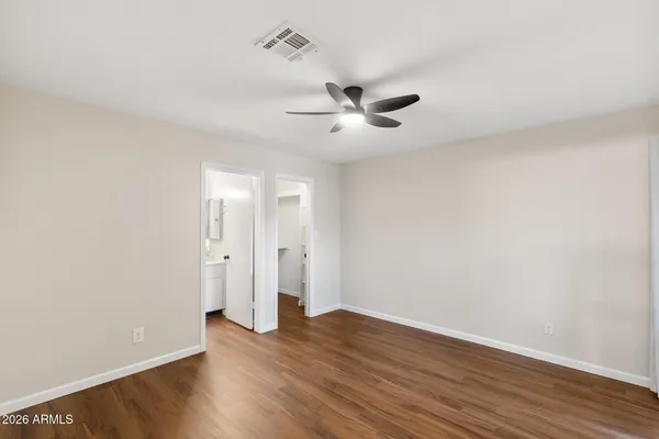 a view of an empty room and wooden floor