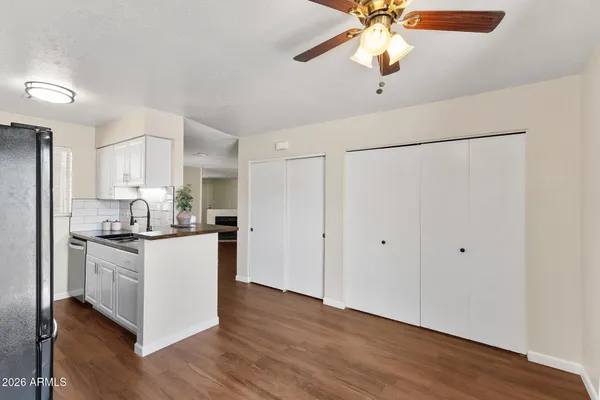 a kitchen with stainless steel appliances a stove a refrigerator and white cabinets