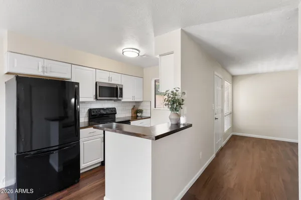 a kitchen with stainless steel appliances a refrigerator sink and microwave