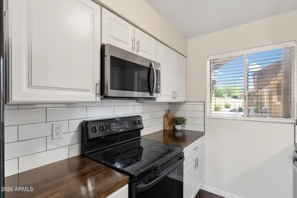 a kitchen with stainless steel appliances a stove a sink and a microwave