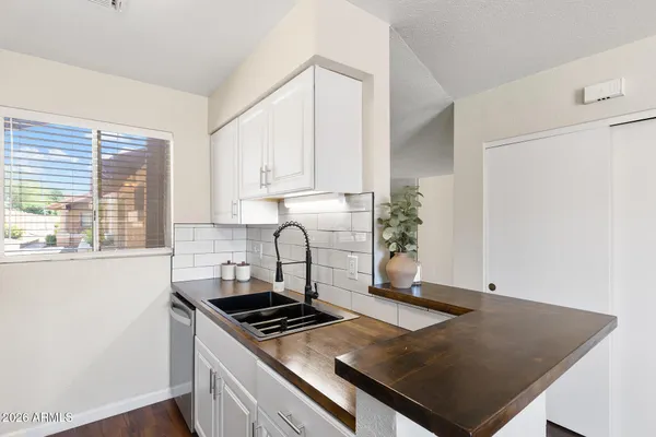a kitchen with a stove cabinets and a window