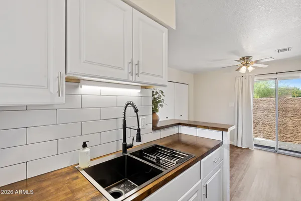a kitchen with granite countertop a stove sink and cabinets