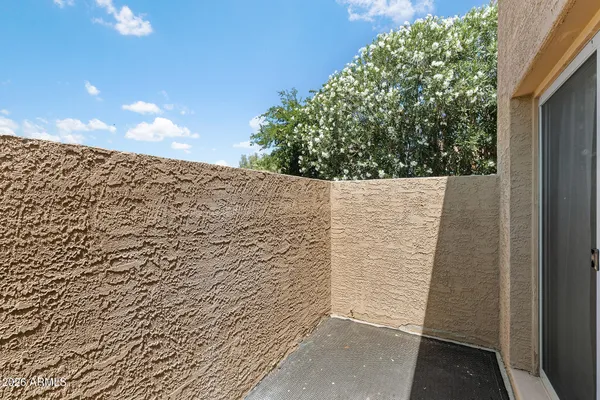 a view of a livingroom with wooden floor and a ceiling fan