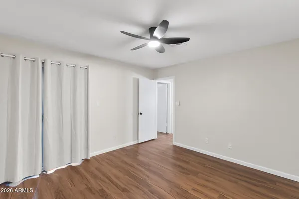 a view of a big room with wooden floor closet and windows