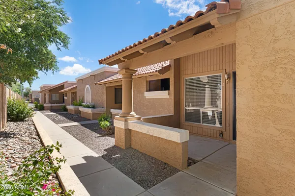 a view of a house with backyard and sitting area