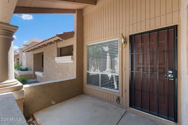 a view of a porch with wooden floor and fence