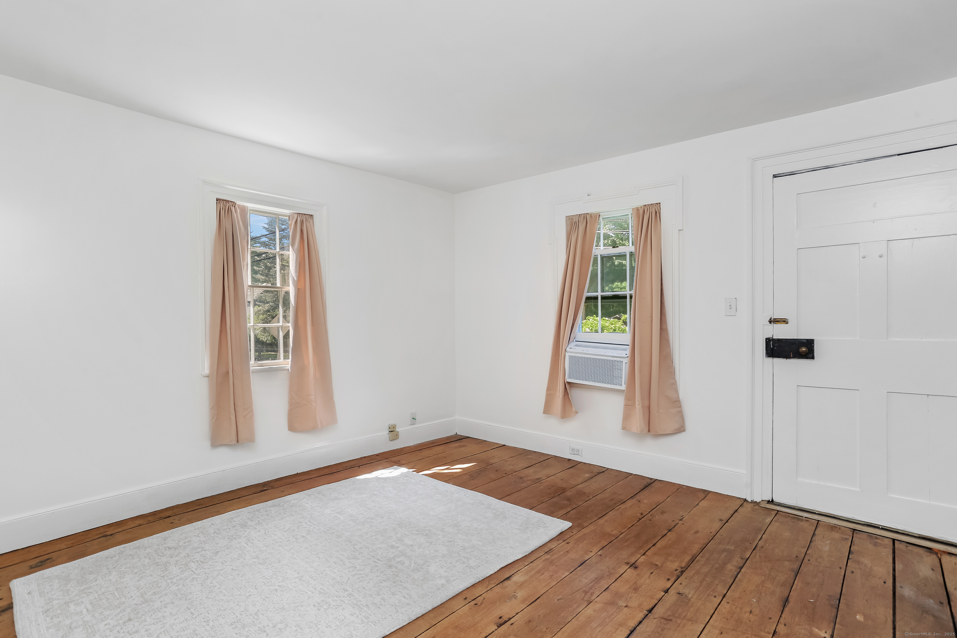 2 Deforest Road Wilton, CT 06897 - Photo 16 of 37 an empty room with wooden floor and windows