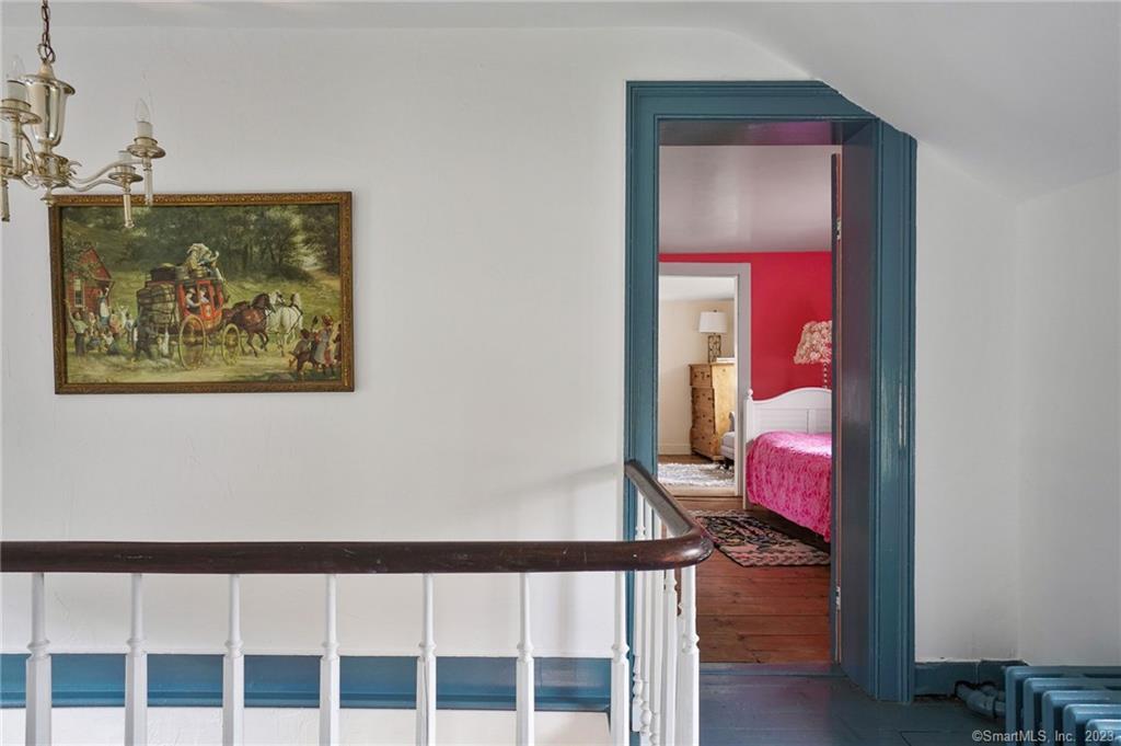 2 Deforest Road Wilton, CT 06897 - Photo 18 of 37 a hallway with a bed and a painting on the wall