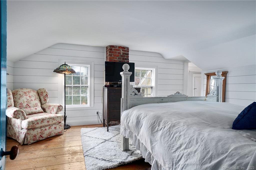 2 Deforest Road Wilton, CT 06897 - Photo 19 of 37 a spacious bedroom with a bed and glass door