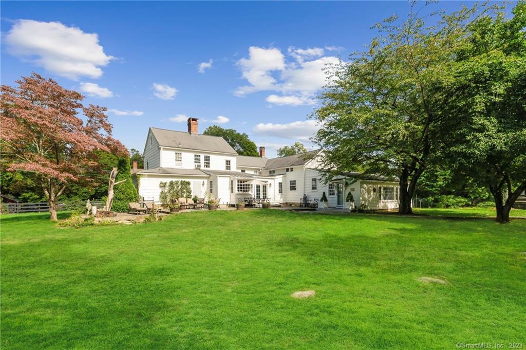 2 Deforest Road Wilton, CT 06897 - Photo 2 of 37 a view of a white house in front of a big yard with large trees