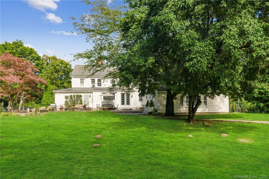 2 Deforest Road Wilton, CT 06897 - Photo 31 of 37 a front view of a house with a garden