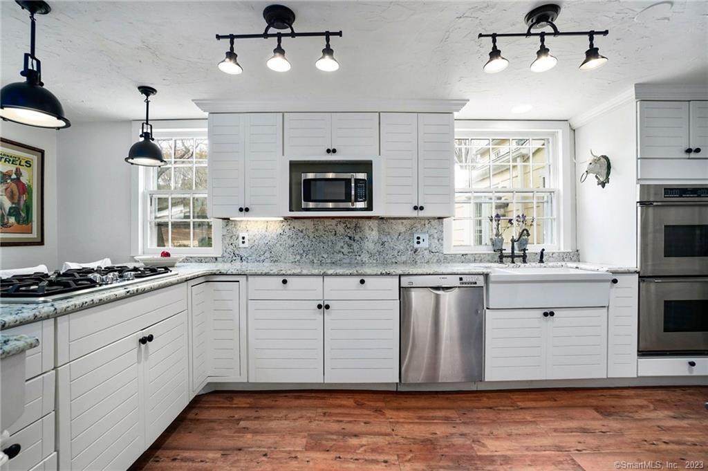 2 Deforest Road Wilton, CT 06897 - Photo 6 of 37 a kitchen with a stove window and cabinets