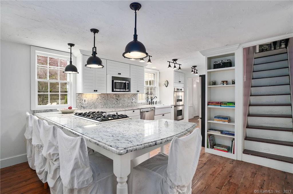 2 Deforest Road Wilton, CT 06897 - Photo 7 of 37 a kitchen with granite countertop a stove and a refrigerator