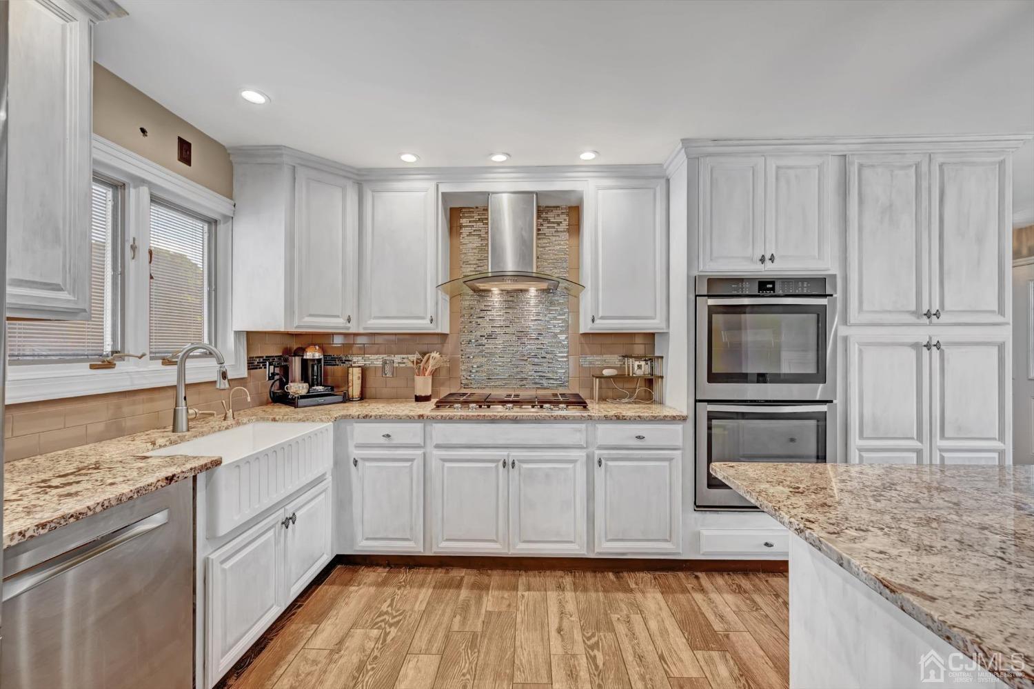 40 Grace Drive Old Bridge, NJ 08857 - Photo 17 of 41 a kitchen with stainless steel appliances granite countertop a stove a sink and a microwave