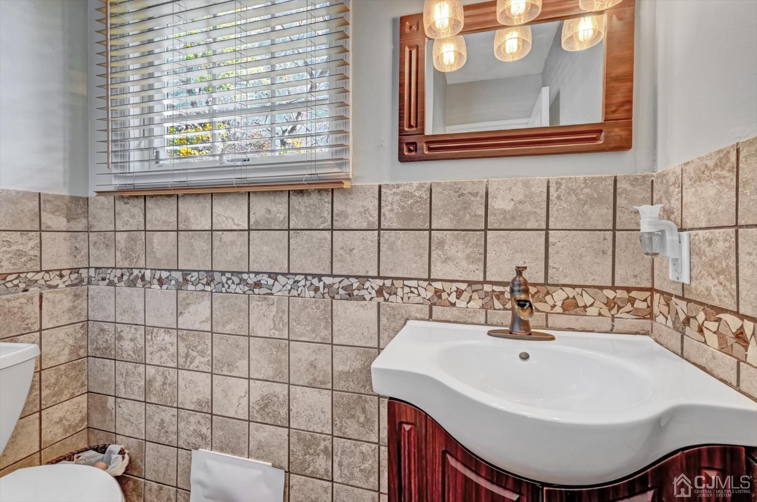 40 Grace Drive Old Bridge, NJ 08857 - Photo 19 of 41 a bathroom with a sink a toilet and a mirror