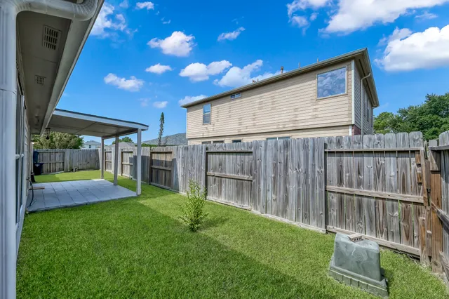 a backyard with table and chairs and a yard