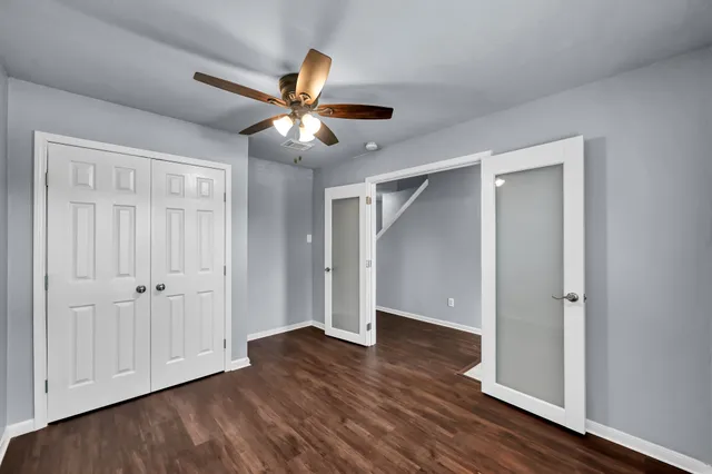 a view of empty room with wooden floor