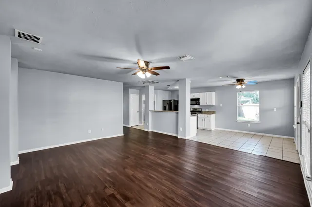 wooden floor in an empty room with a window