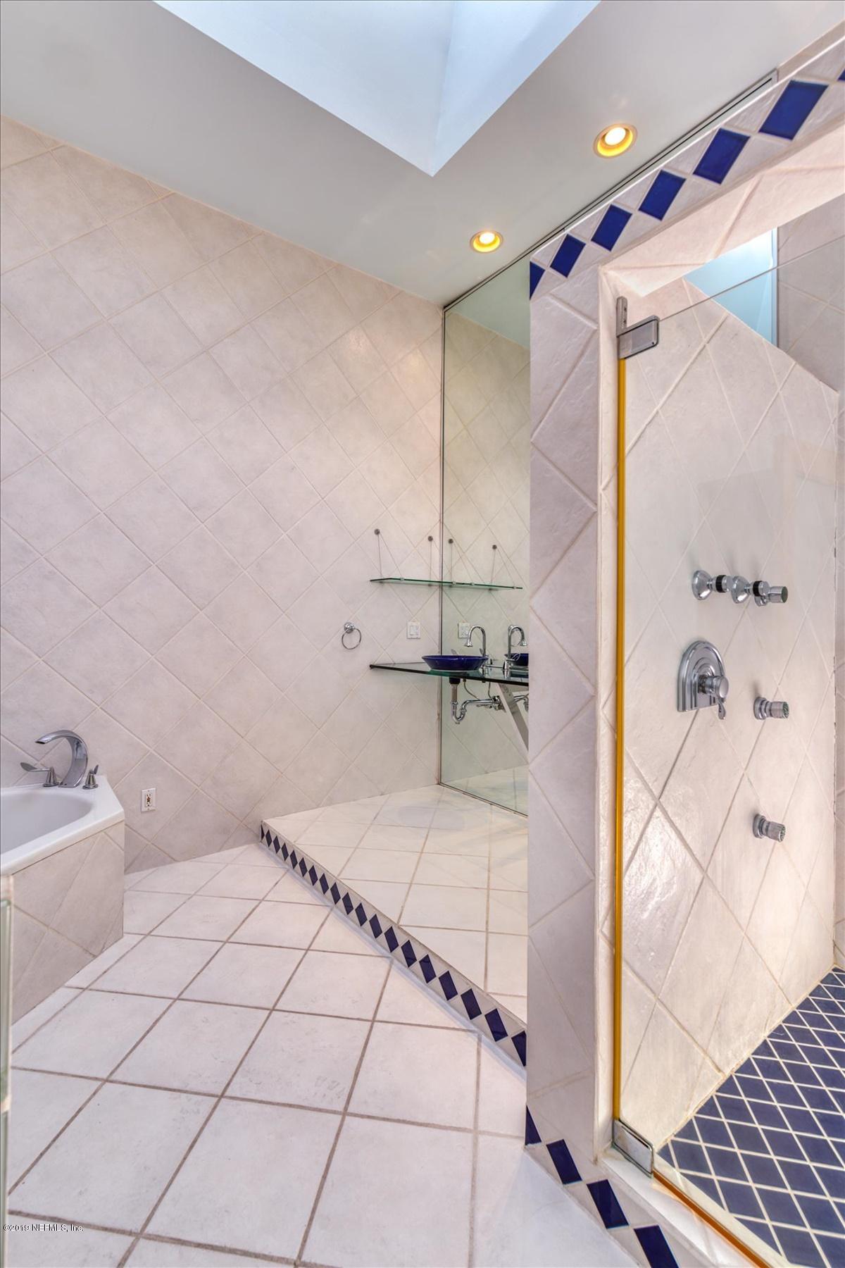 39 Adams Street Jacksonville, FL 32202 - Photo 11 of 29 a bathroom with a bathtub and a shower