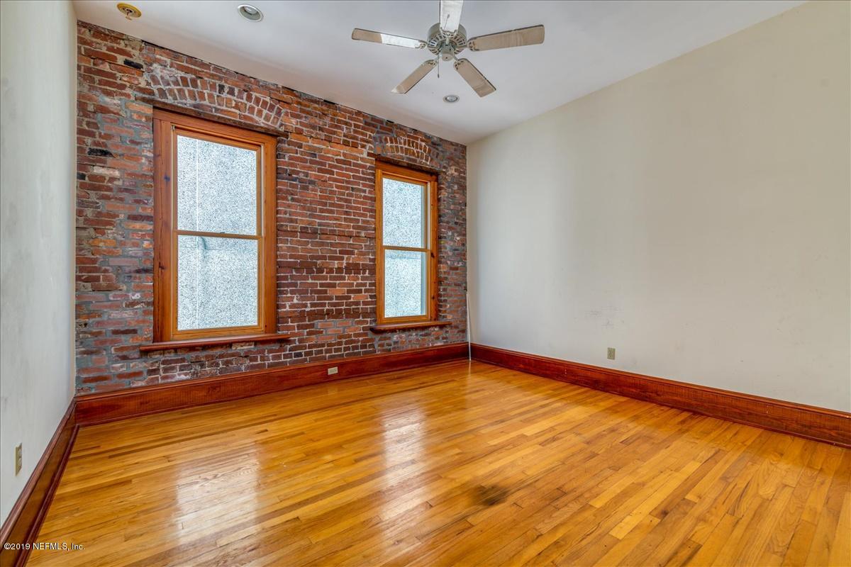 39 Adams Street Jacksonville, FL 32202 - Photo 20 of 29 a view of an empty room with a window and wooden floor
