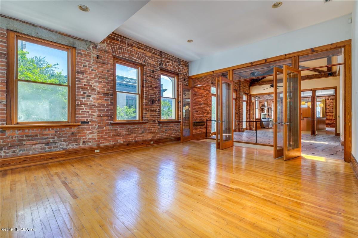 39 Adams Street Jacksonville, FL 32202 - Photo 21 of 29 a view of an empty room with wooden floor and a window