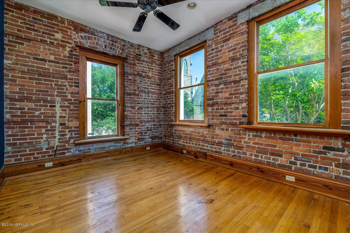 39 Adams Street Jacksonville, FL 32202 - Photo 22 of 29 a view of an empty room with a window and wooden floor