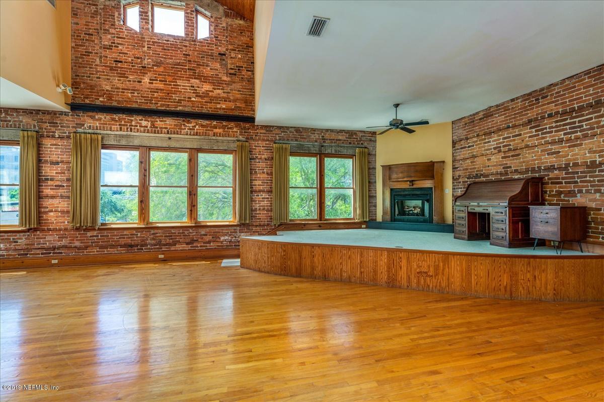39 Adams Street Jacksonville, FL 32202 - Photo 8 of 29 a view of an empty room with wooden floor and a window