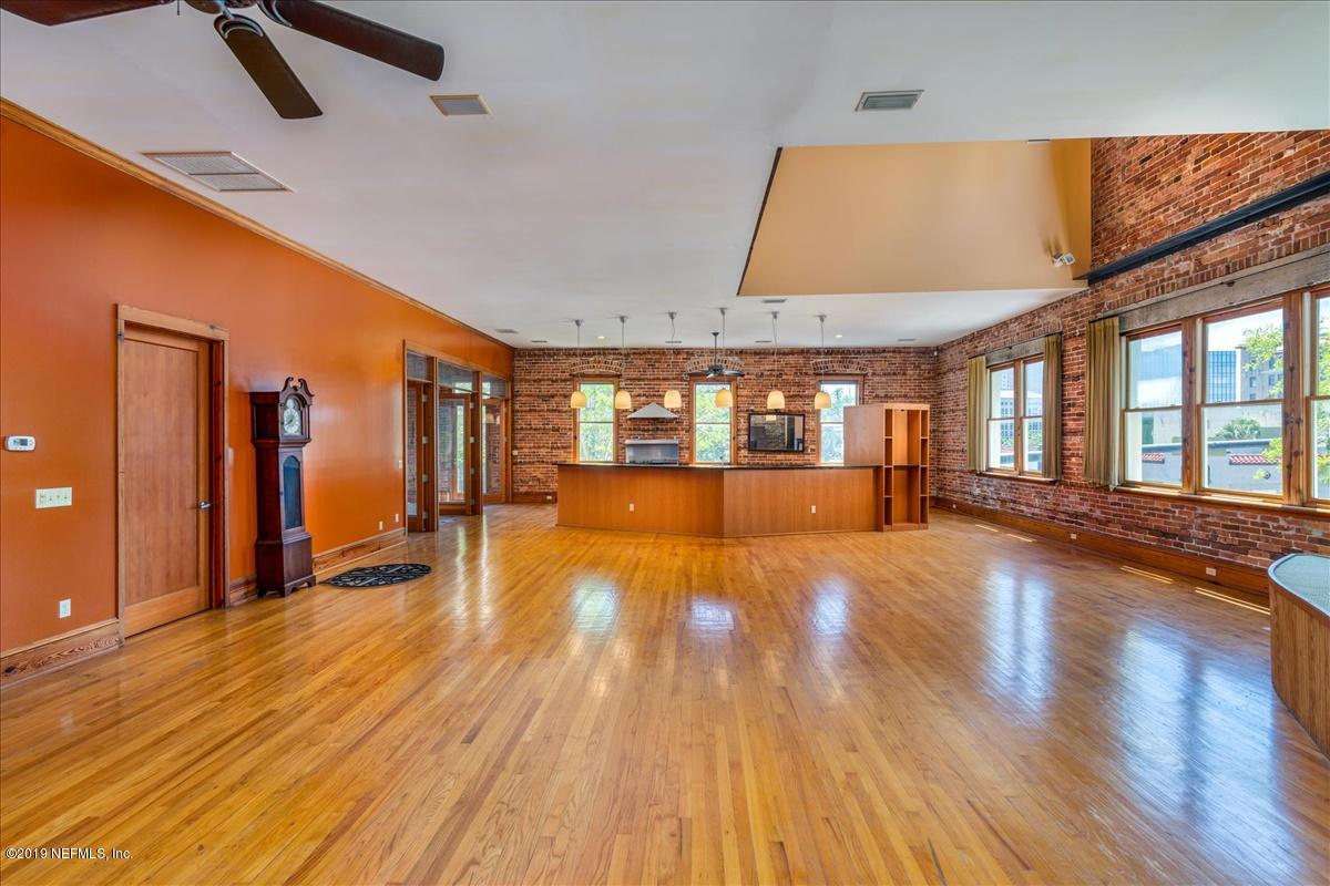 39 Adams Street Jacksonville, FL 32202 - Photo 9 of 29 an empty room with wooden floor and windows