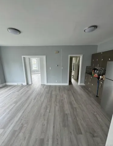 a view of a livingroom with wooden floor and furniture