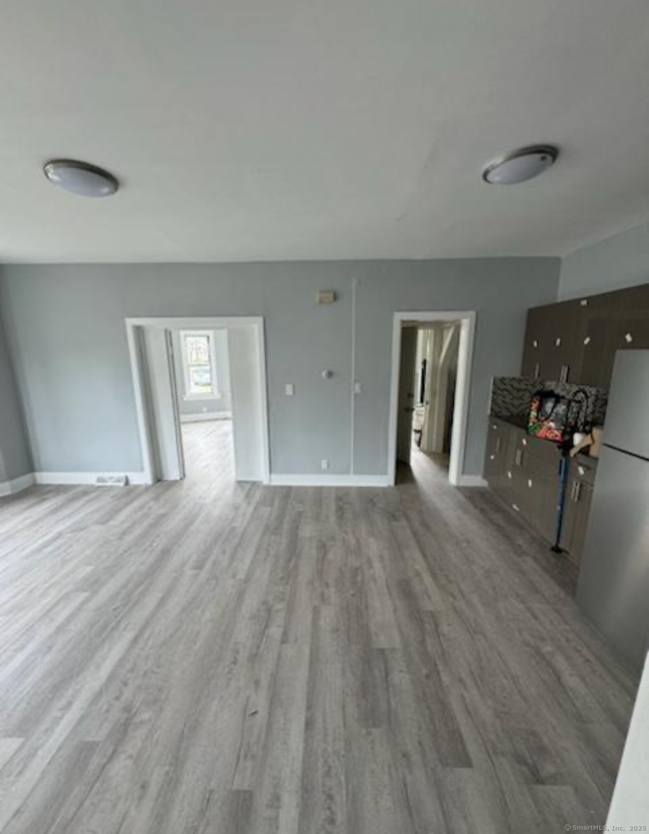 a view of a livingroom with wooden floor and furniture