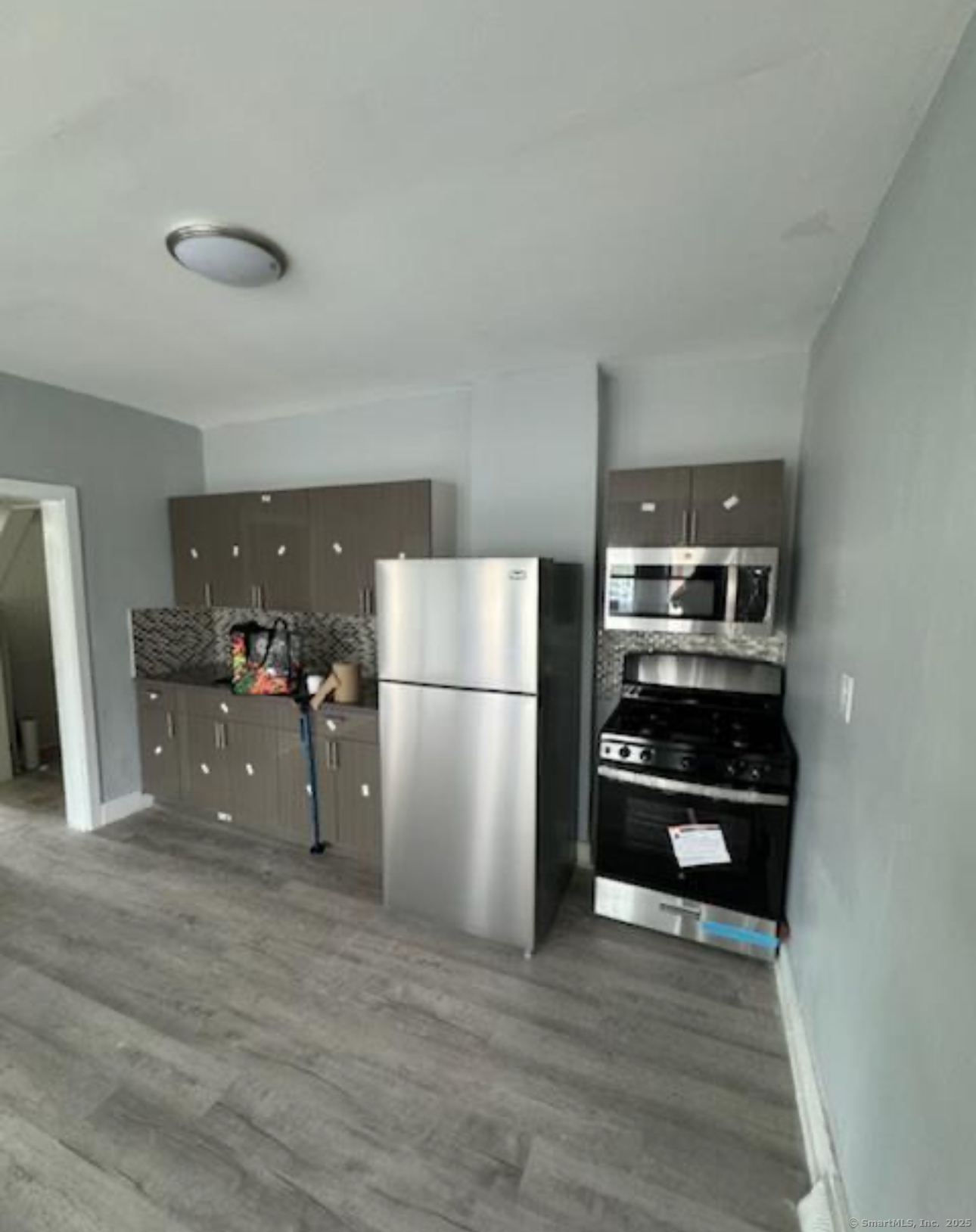 655 Maple Street, Unit 2 Bridgeport, CT 06608 - Photo 2 of 4 a kitchen with stainless steel appliances a refrigerator and a stove top oven