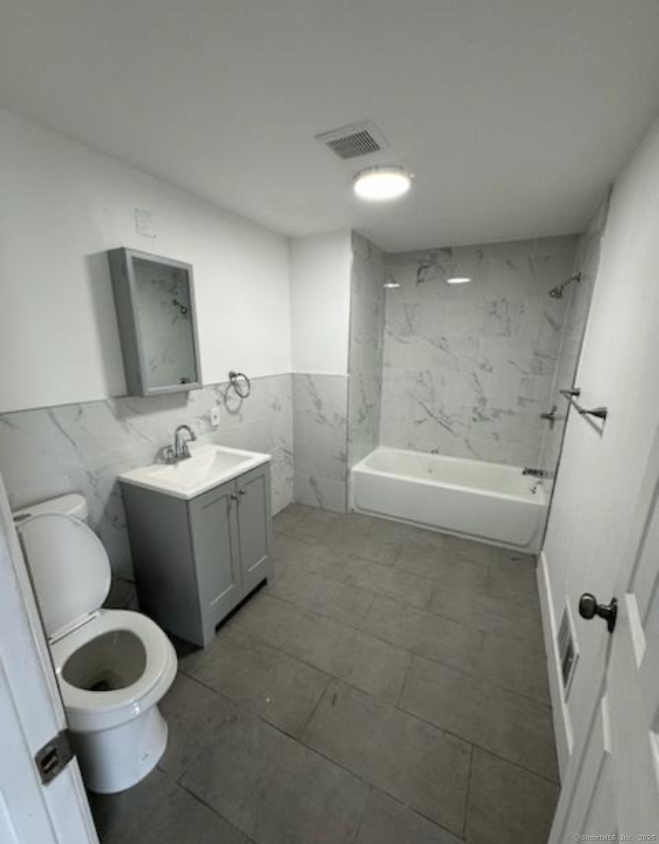 655 Maple Street, Unit 2 Bridgeport, CT 06608 - Photo 4 of 4 a bathroom with a bathtub sink and toilet
