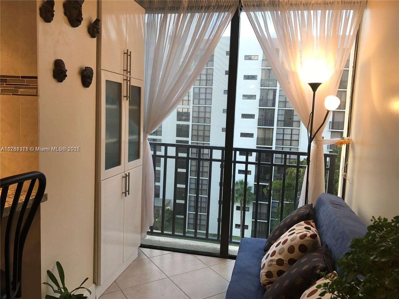 17011 North Bay Road, Unit 701 Sunny Isles Beach, FL 33160 - Photo 11 of 41 a view of a living room and a balcony