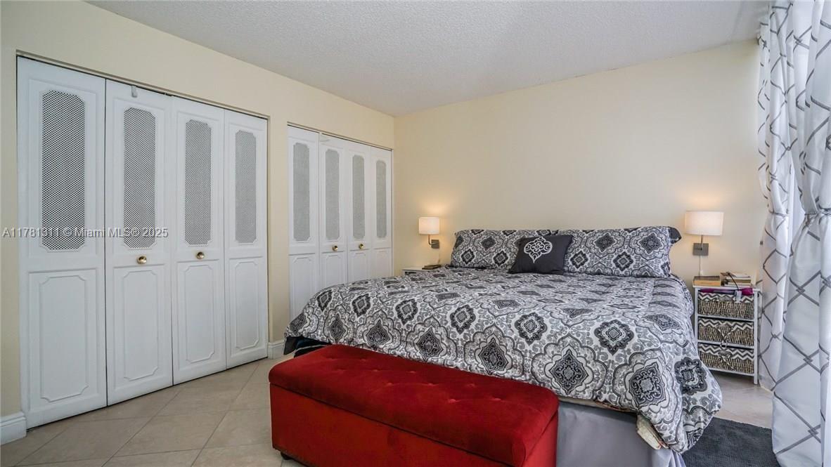 17011 North Bay Road, Unit 701 Sunny Isles Beach, FL 33160 - Photo 13 of 41 a bed sitting in a bedroom next to a bathroom
