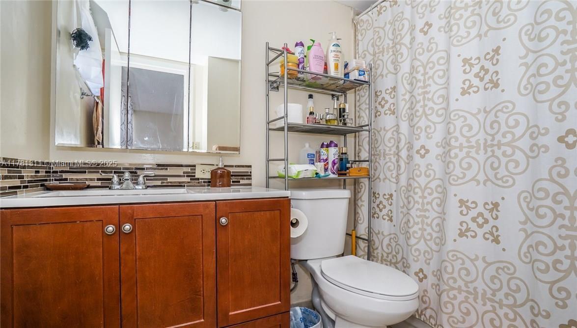 17011 North Bay Road, Unit 701 Sunny Isles Beach, FL 33160 - Photo 14 of 41 a bathroom with a toilet sink and mirror