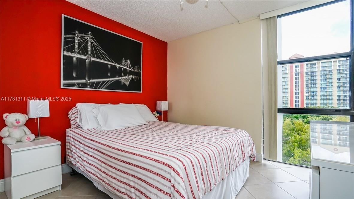 17011 North Bay Road, Unit 701 Sunny Isles Beach, FL 33160 - Photo 15 of 41 a bedroom with a bed and a window