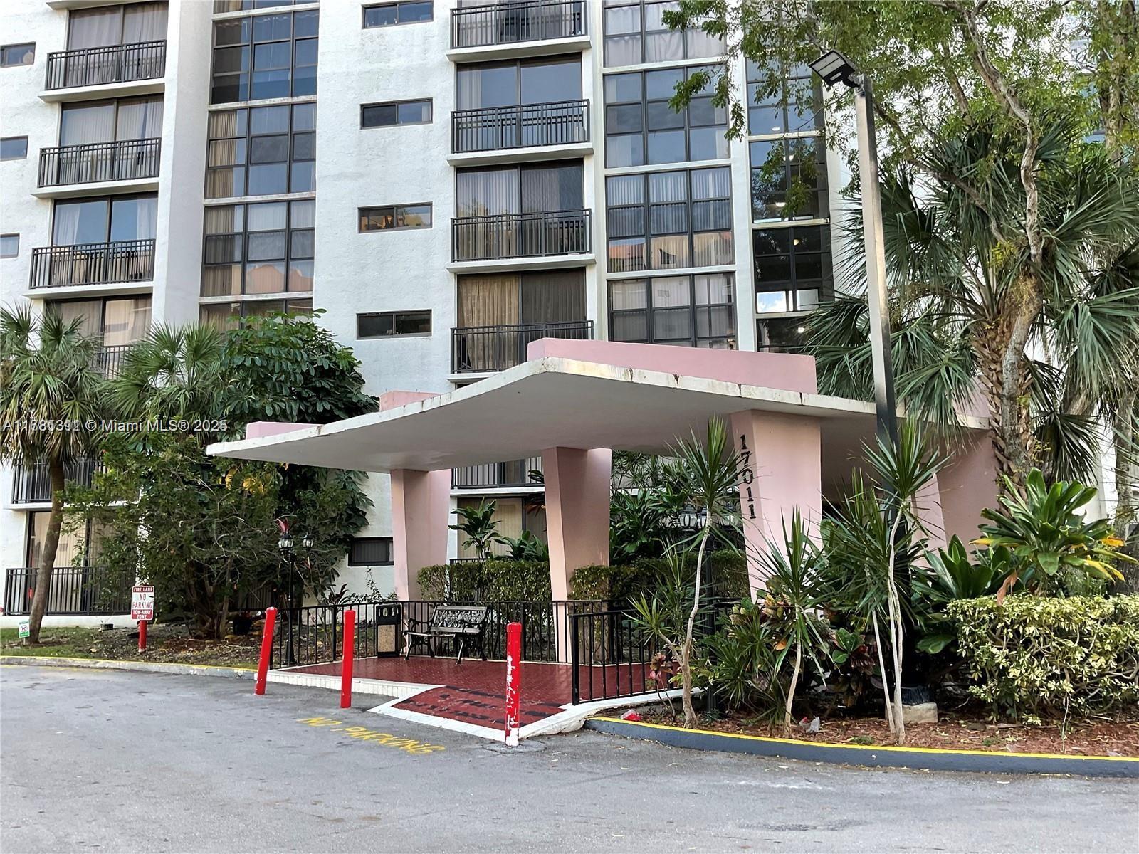 17011 North Bay Road, Unit 701 Sunny Isles Beach, FL 33160 - Photo 20 of 41 a view of a building with a porch and a yard