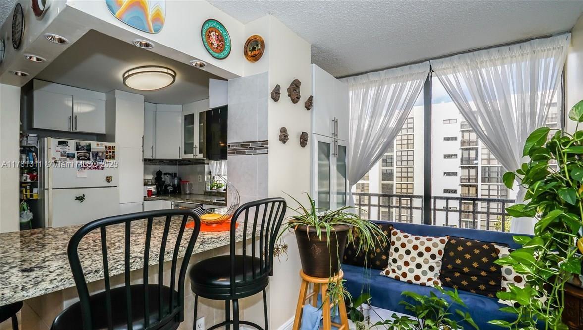 17011 North Bay Road, Unit 701 Sunny Isles Beach, FL 33160 - Photo 6 of 41 a view of a dining room with furniture and a large window