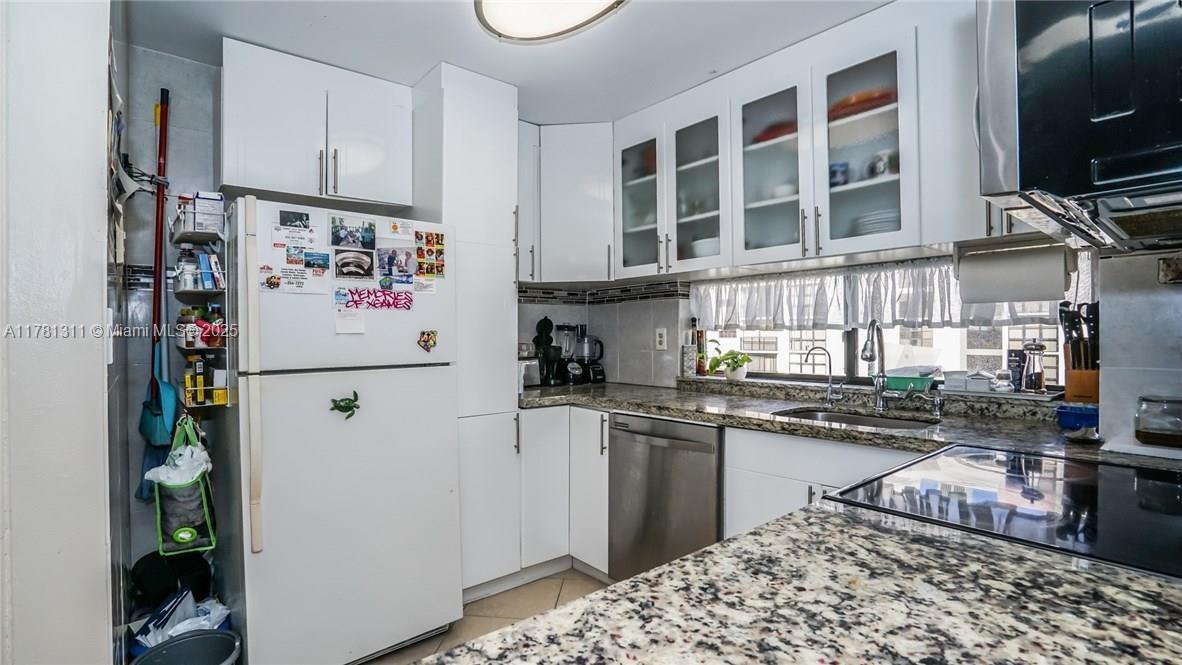 17011 North Bay Road, Unit 701 Sunny Isles Beach, FL 33160 - Photo 8 of 41 a kitchen with stainless steel appliances granite countertop a refrigerator and a stove top oven