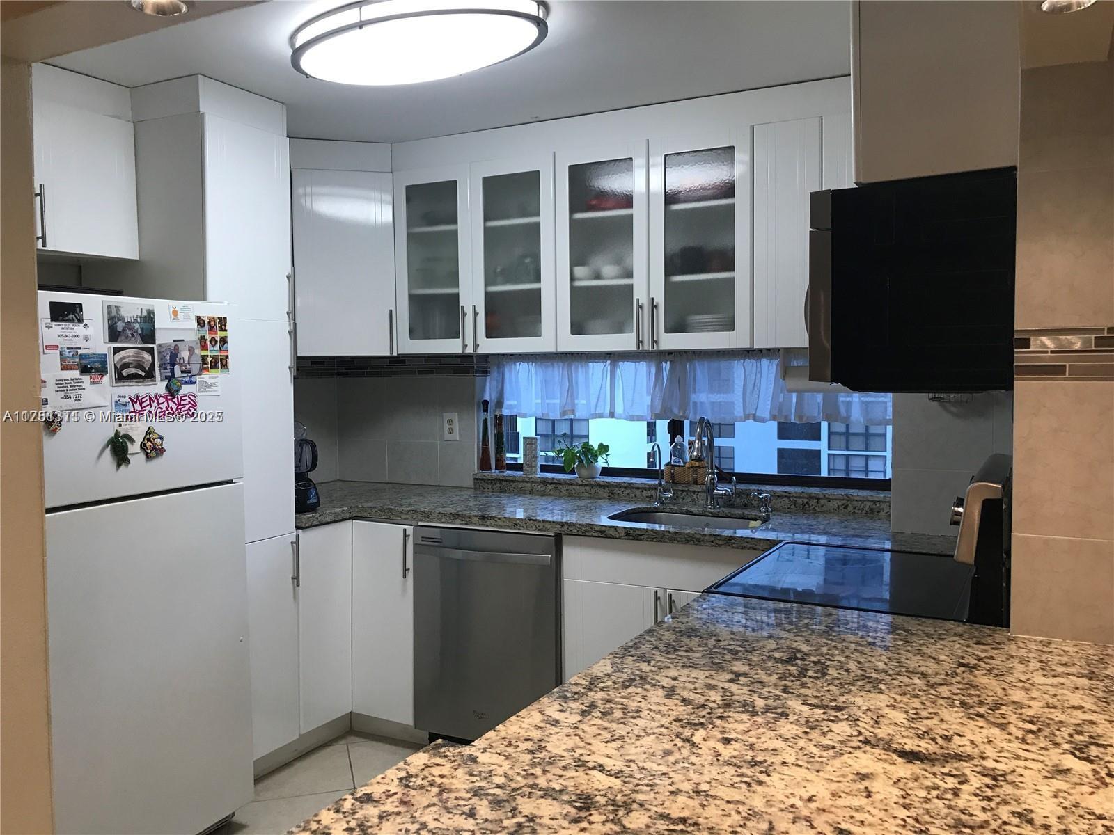 17011 North Bay Road, Unit 701 Sunny Isles Beach, FL 33160 - Photo 10 of 41 a kitchen with stainless steel appliances granite countertop a refrigerator stove and a sink