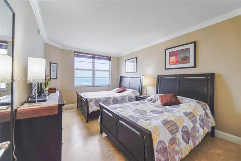 a bedroom with a bed and dresser with mirror