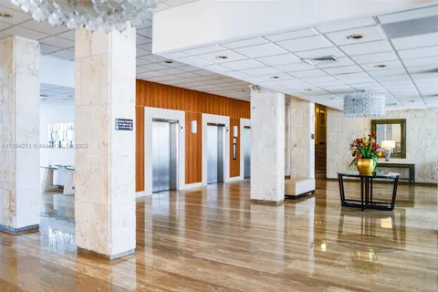 a lobby with furniture and rug