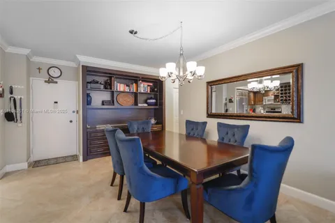 a view of a dining room with furniture a chandelier and wooden floor