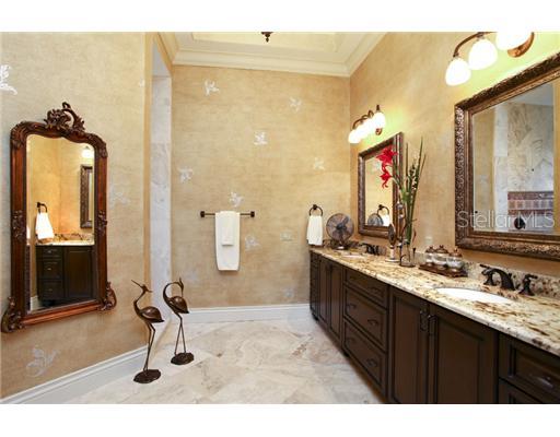 16005 4th Street East Redington Beach, FL 33708 - Photo 9 of 12 Master Bath - Plush master bath includes a magnificent marble shower w/tumbled marble inserts, private water closet, tray ceilings, huge his and her cherry vanity, granite counters, exceptional blackened bronze fixtures and fine wood trim finishes.