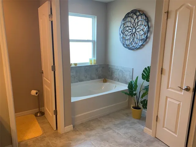 a bathroom with a tub sink and shower